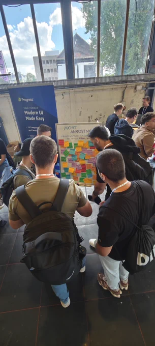 People adding sticky notes to a board