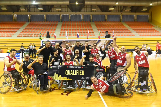 Iran team celebrating win over Poland, holding “qualified” sign confirming qualification.