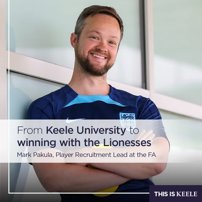 A person smiling and leaning against a glass wall. They are wearing a sports shirt featuring the England football team logo. The text reads: "From Keele University to winning with the Lionesses. Mark Pakula, Player Recruitment Lead at the FA." The bottom corner shows the logo "This is Keele".