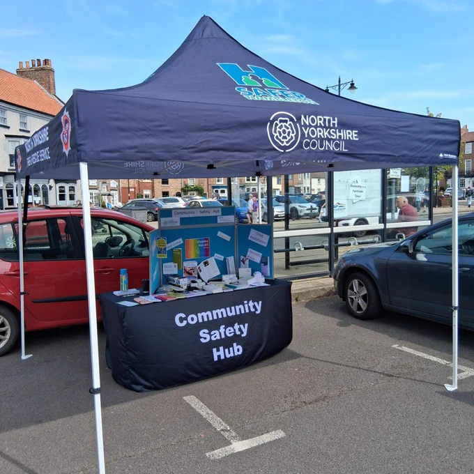 A 'Community Safety Hub' gazebo with North Yorkshire Council branding, displaying information leaflets.