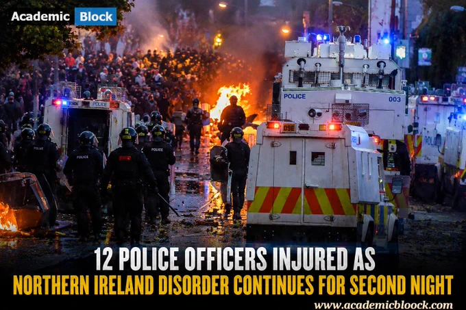 Police officers in riot gear responding to nighttime civil disorder, with water cannon deployed and emergency lights illuminating the scene.
