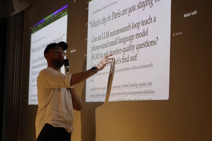 Me, trying to touch the future while giving a quick demo of "'Which city in Paris are you staying in?'–Can an LLM autoresearch loop teach a phone-sized small language model (SLM) to ask frontier-quality questions? Can it? Does it? Let's find out!"