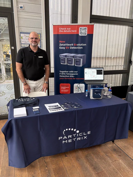 Particle Metrix exhibition booth at JDD MYCo 2026 at Institut Pasteur. A team member is presenting the ZetaView® Evolution system and discussing nanoparticle and extracellular vesicle (EV) characterization with conference attendees.