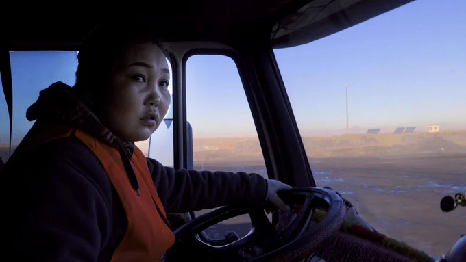 A female trucker at the wheel