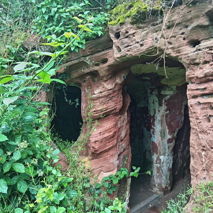 A sandstone rock house in the woods.