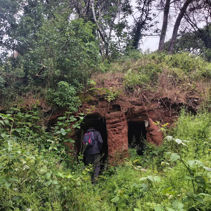 A sandstone rock house in the woods.