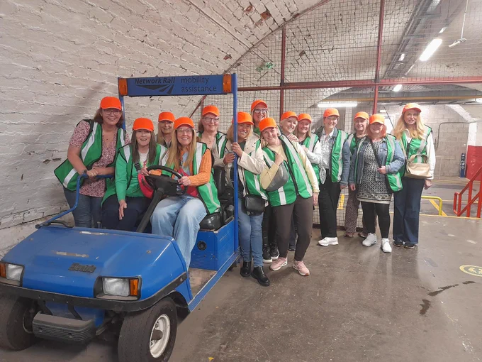 A tour group by the mobility buggy.