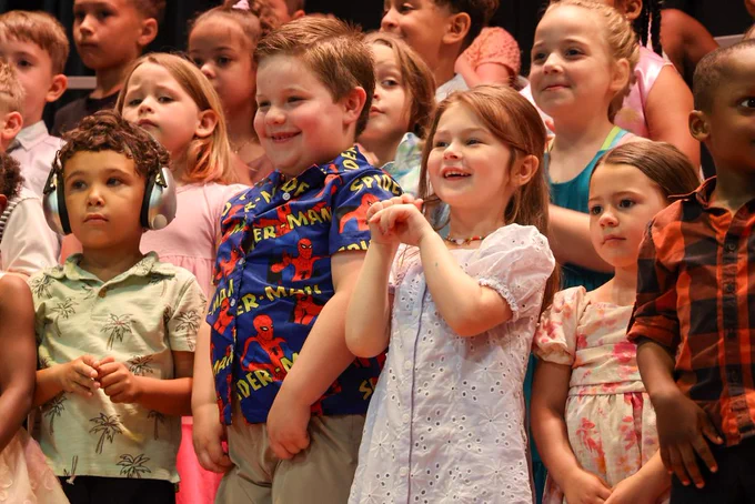 student students smile on stage 