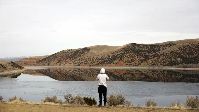 A person peers at Echo Reservoir in Coalville, Utah. (Credit: GettyImages)