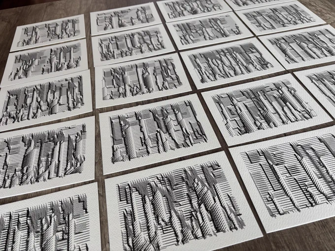 Grid of textured black and white abstract drawings on individual white cards, arranged in an orderly pattern on a wooden surface