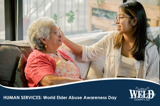 Young woman gently comforting elderly woman on a couch, highlighting elder care and support.