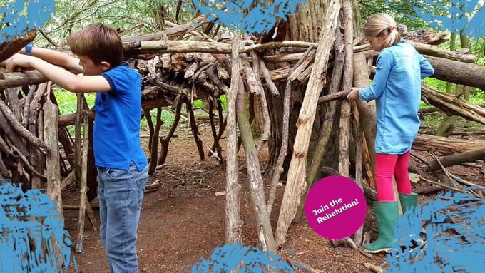 Children building a fort made of wood in the park