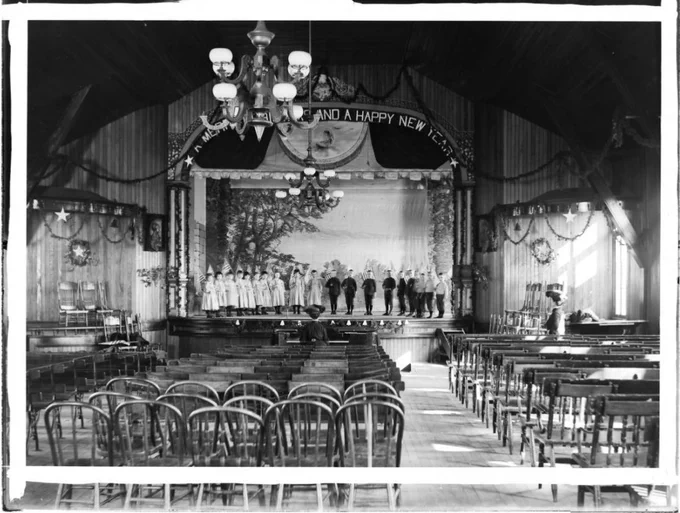 A black and white photo of children on a stage.