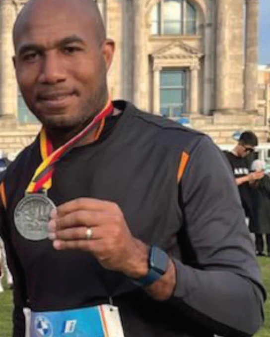 Joel holding a medal