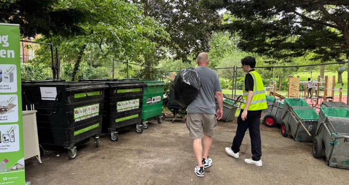 Image shows a resident dropping off unwanted items at a previous community skip event