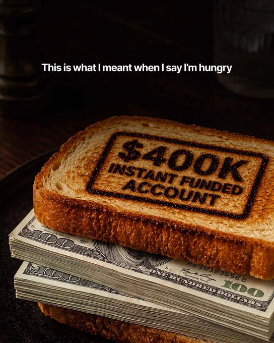 A humorous image showcasing a slice of toast branded with '$400K Instant Funded Account' placed atop stacks of $100 bills. The text 'This is what I meant when I say I'm hungry' adds a playful touch.