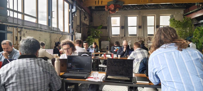 People at a conference working on their laptops