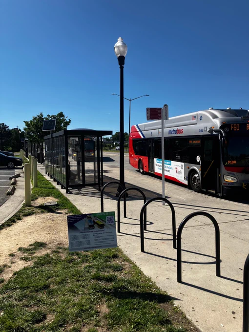 F60 bus at transfer station with Envision Route 7 sign in foreground