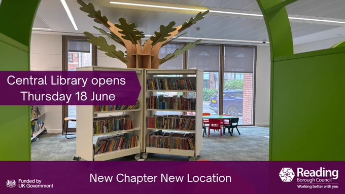 The entrance to the new Children's library through a green arch into a forest themed library