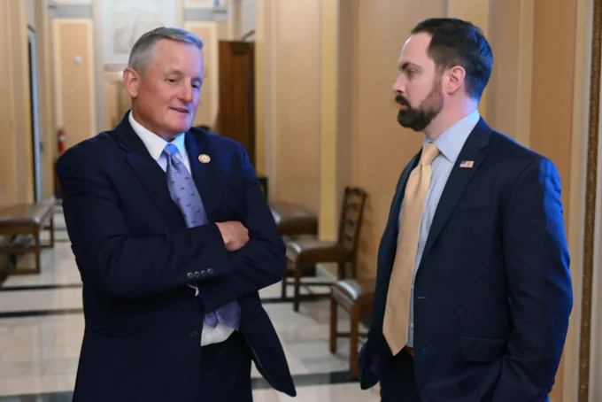 Congressman Bruce Westerman and EPA Regional Administrator Scott Mason standing and talking in a hallway.