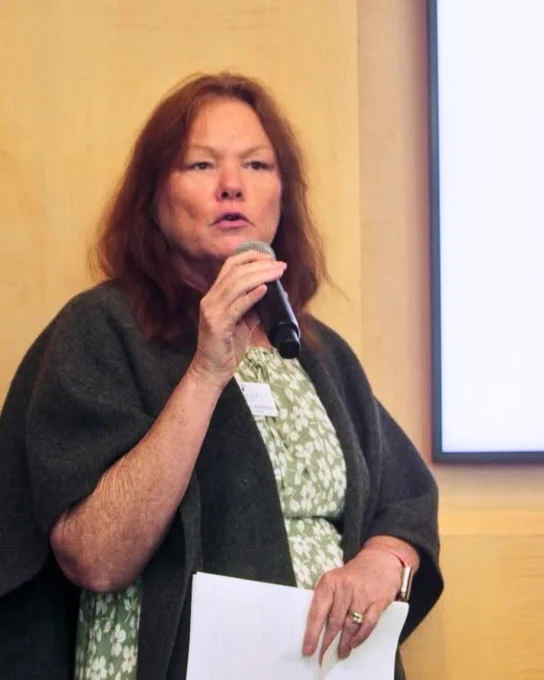 (Photo) Carol Brady-Simmons, Miami Lighthouse Chief Program Officer speaks into a microphone during a presentation.