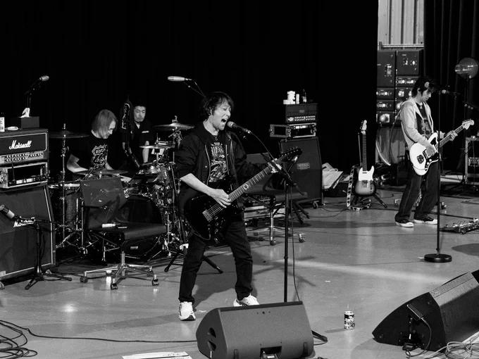 A black and white photograph of The Primals rehearsing.