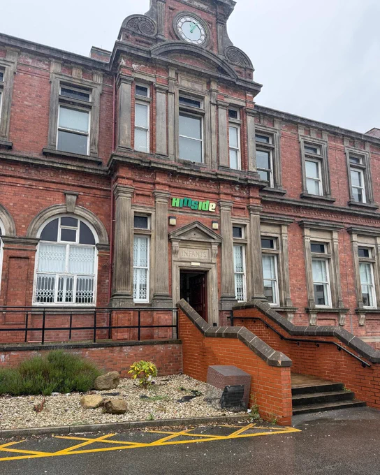 Outside of the Hillside house in Beeston, where Leeds Safeguarding Adults Board held training for third sector organisations. 
A grand, red-brick building with a clock at the top of it.