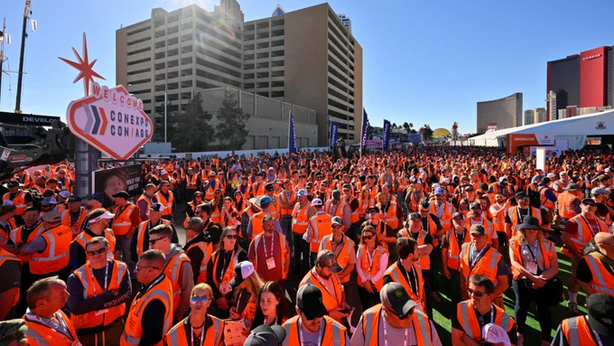 A large crowd of construction workers wearing bright orange safety vests at CONEXPO-CON/AG 2026.
