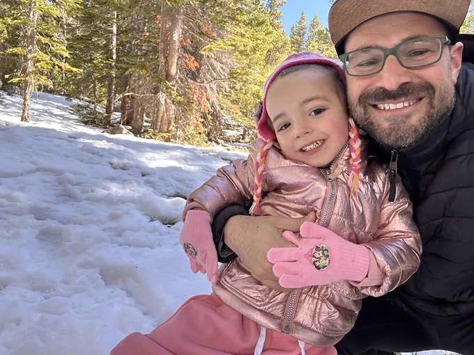 Jonathan Weitz and child in the snow