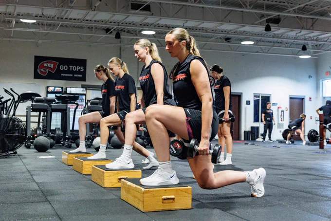 Lady Topper Basketball players lifting weights