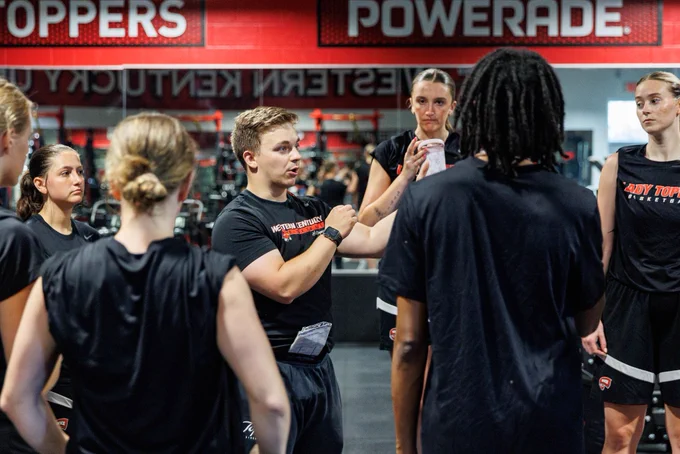 Team huddle around strength and conditioning coach Parker Cheuvront