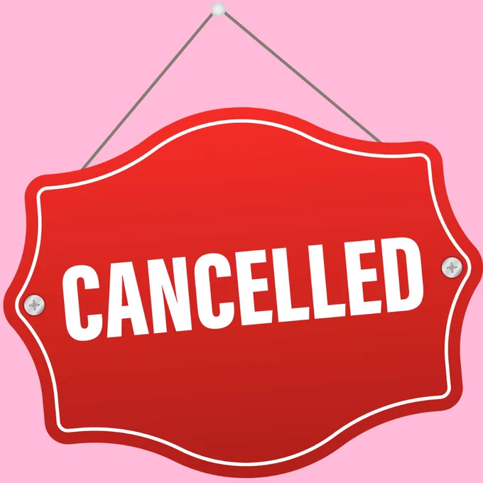 Red sign on a pink background reading "Cancelled" 
