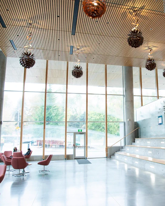 Large open atrium study space with seating and wide stairs inside BCIT's Health Sciences Centre.