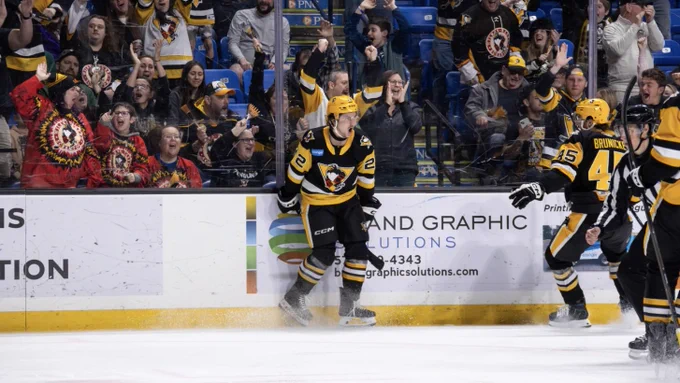 Photo of Tanner Howe celebrating on the ice. 