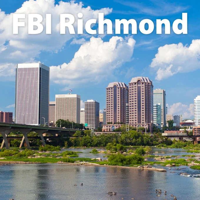 Richmond city skyline with tall buildings under a bright blue sky and the James River in the foreground.