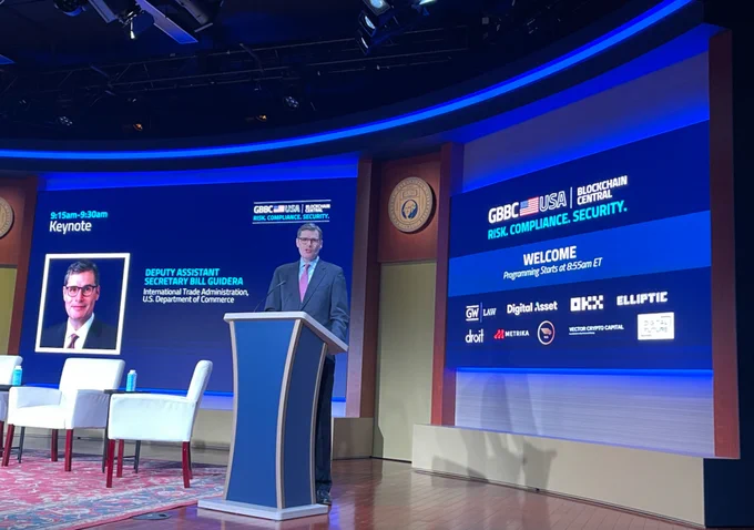 Photo featuring DUS Guidera speaking from a podium on a stage.