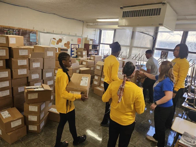 RGHS students carrying boxes and organizing room