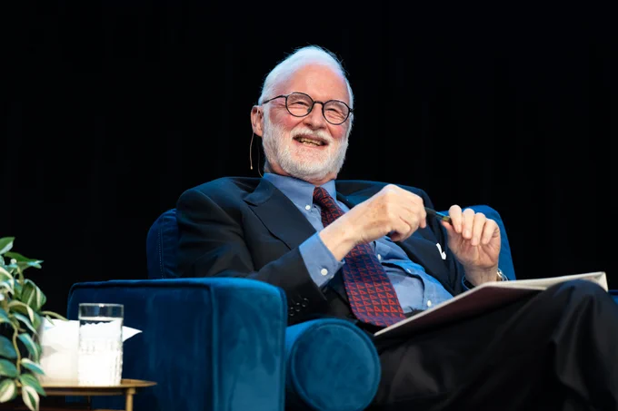 Ambassador Robert Fowler sitting on stage during the event. 