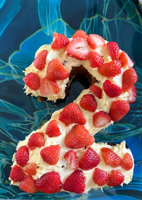Number two-shaped cake topped with strawberries and cream