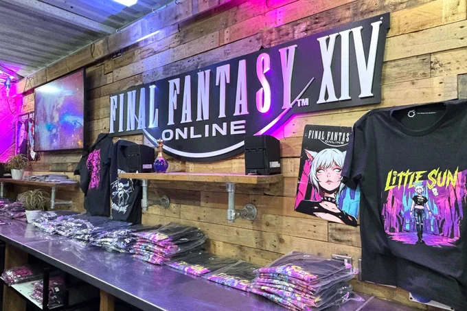 A photograph of the Final Fantasy 14 stand at Download Festival. The Final Fantasy 14 Online logo is on a wooden wall surrounded by T-shirts and posters.