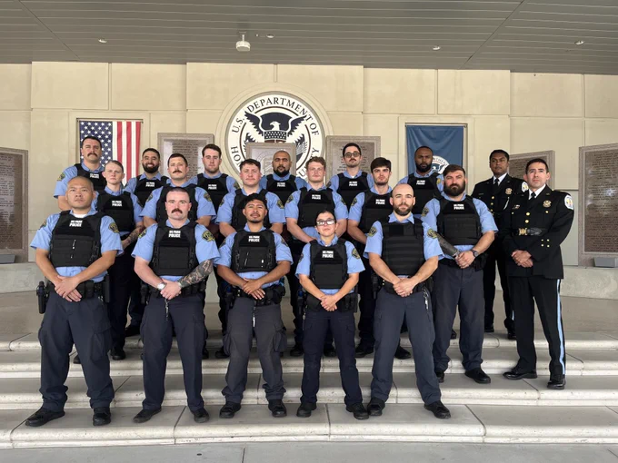 Group portrait of 17 U.S. Park Police recruits standing in formation with instructors following graduation from basic law enforcement training.