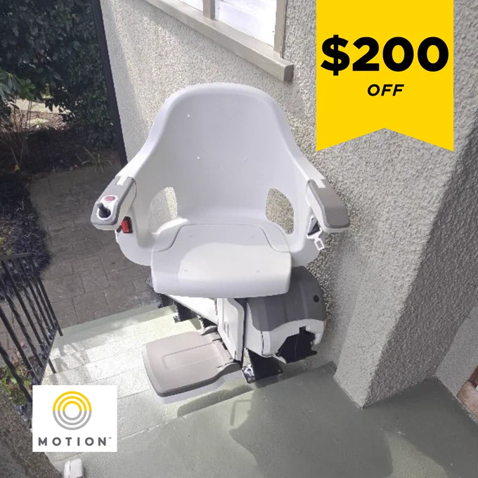 White stairlift chair installed on outdoor steps beside a house wall with a $200 off promotional banner. The Motion logo also appears.