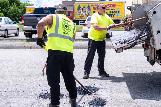 Photo of DPW employees filling potholes