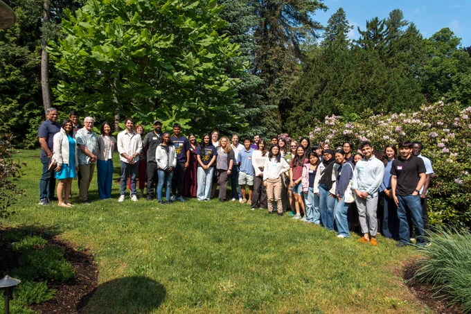 large group standing together on grass in garden