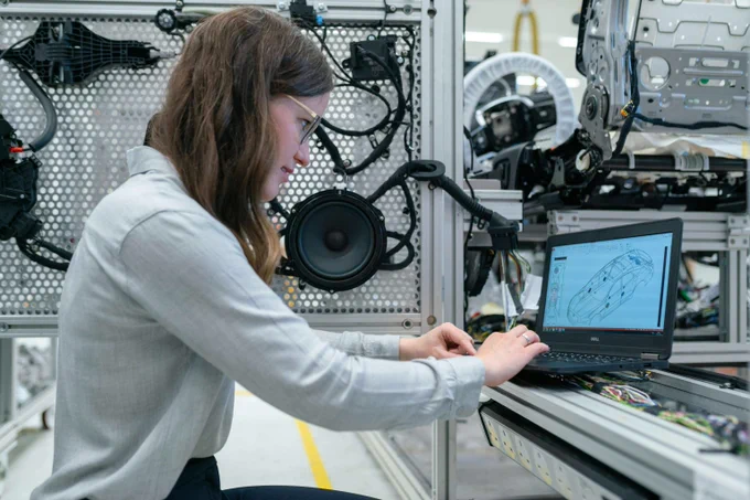 An engineer working on a computer in a technical workshop. 