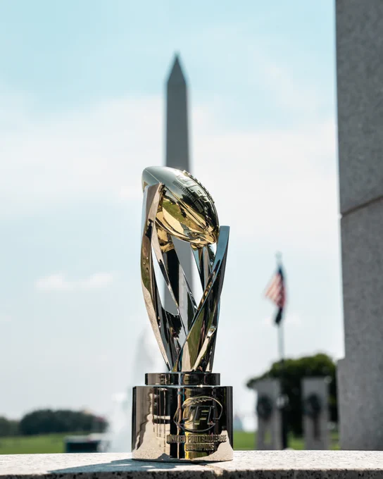A gleaming championship trophy positioned with the Washington Monument in the background, capturing a patriotic and prestigious atmosphere.