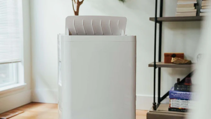 An air conditioner placed in the centre of a room.