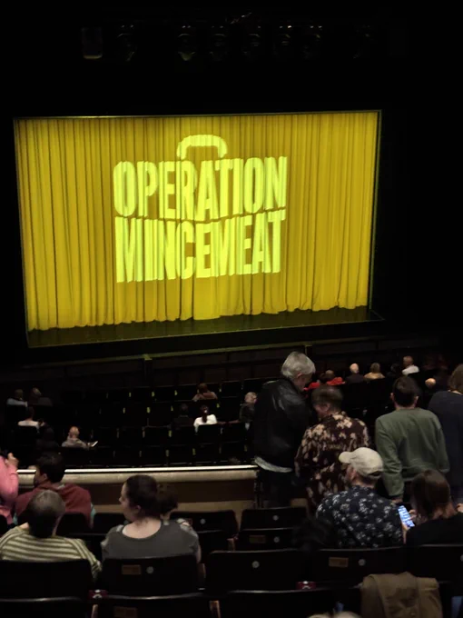 Interior of l Milton Keynes Theatre with the Operation Mincemeat yellow safety curtain 