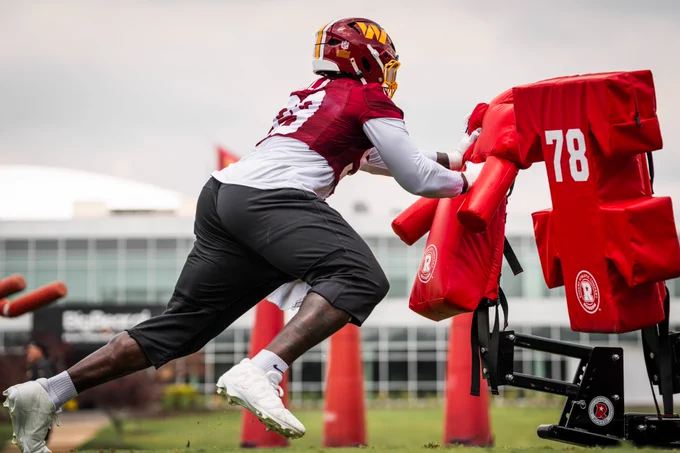 Photo. Javon Kinlaw doing a football drill.