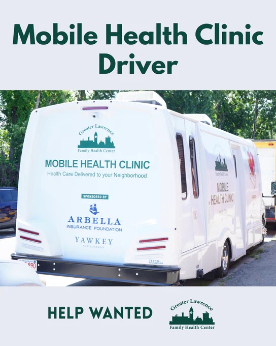Rear view of a blue mobile health clinic vehicle parked outdoors with Greater Lawrence Family Health Center branding.